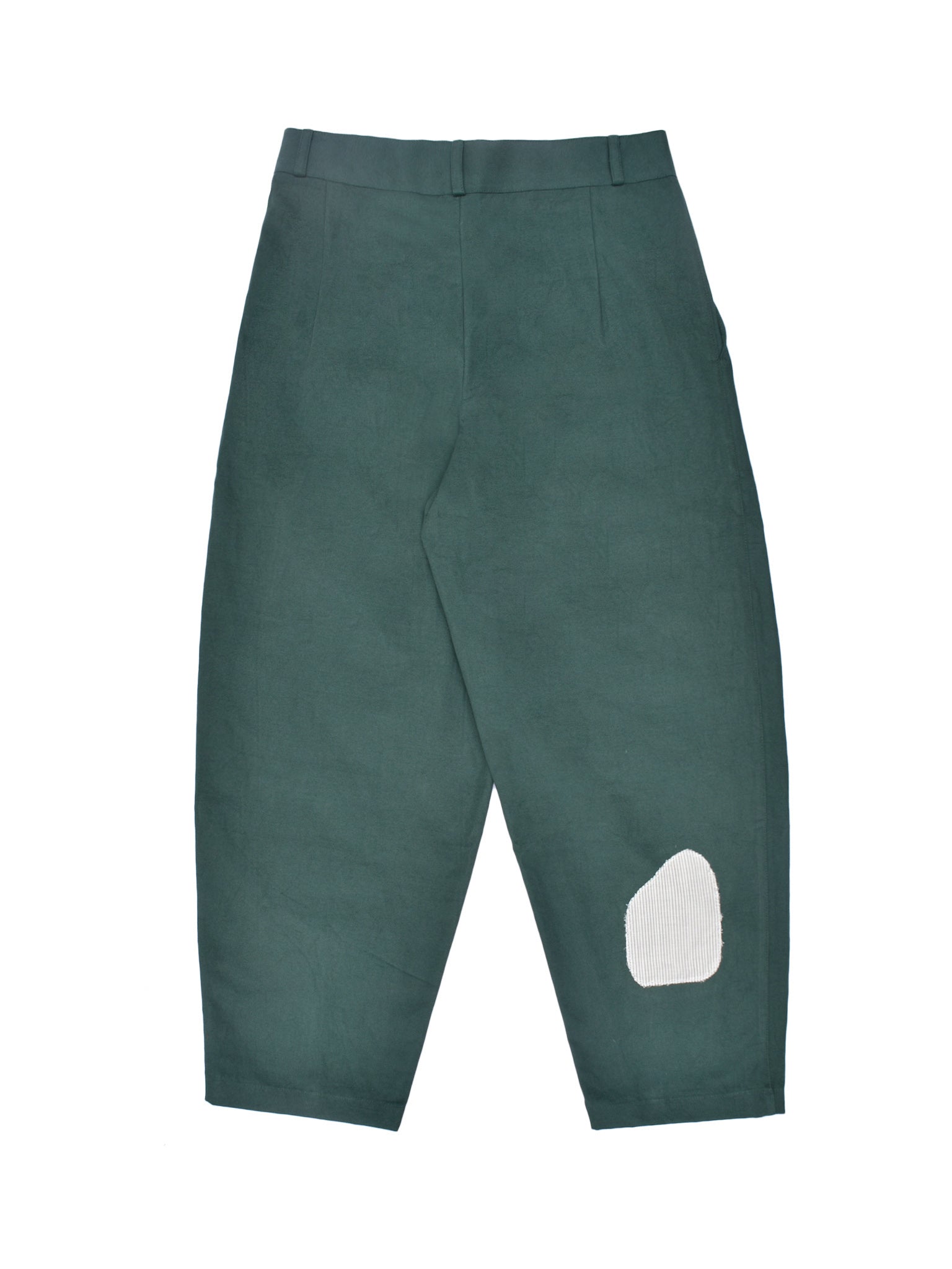 Green pants with a white patch on a white background