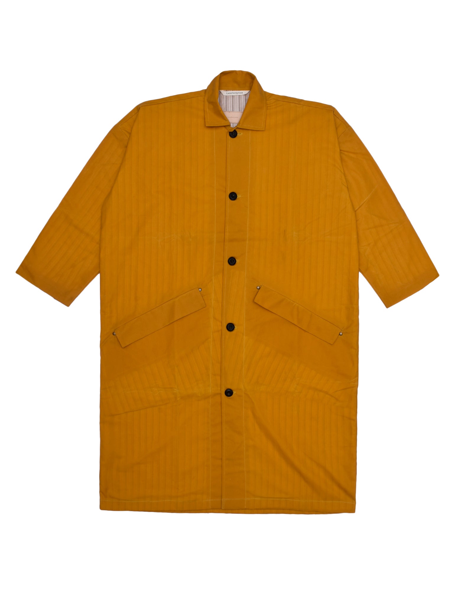 Yellow raincoat with black buttons on a white background