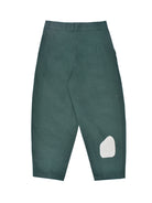 Green pants with a white patch on a white background