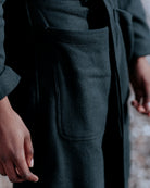 Black trousers with a pocket detail, blurred background