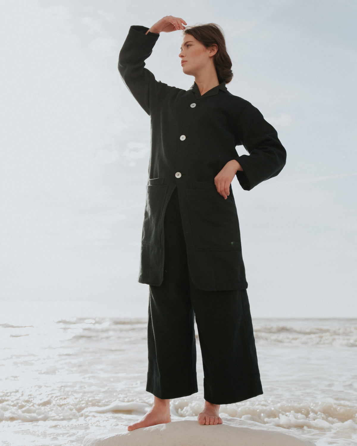 Person wearing a black outfit standing on a snowy landscape