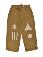 Brown pants with geometric and abstract embroidery on a white background