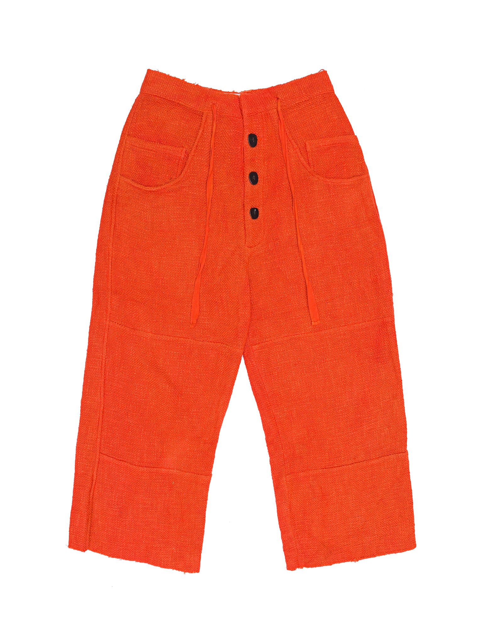 Orange corduroy pants with black buttons on a white background